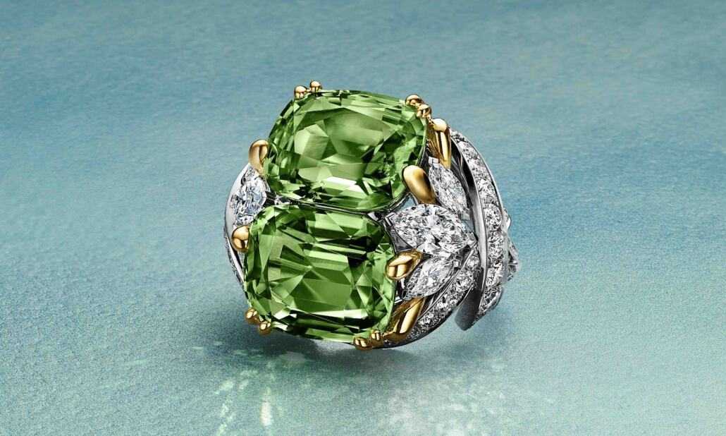 Petals Unenhanced Peridot Ring Ring in platinum and 18k yellow gold with two cushion-cut unenhanced peridots of 15.92 total carats and diamonds © TIFFANY & Co.